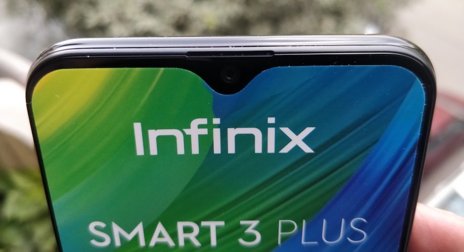 Infinix Smart 3 Plus (X627V) is a feature-packed entry-level budget mobile phone, it has a triple rear camera, 6.21 inches HD+ display, MediaTek A22 Quad Core 2.0GHz processor and 3500 mAh Li-ion Polymer Battery. If I am not wrong then Infinix Smart 3 Plus (X627V) is the only mobile phone in the price range of Rs. 7k which comes with the three rear camera lens setup. Infinix has launched the Smart 3 Plus in a segment which is the most crowded mobile phone segment in India. In sub 10k segment there are too many phones probably more than any other segment, I shouldn't be surprised if I visited offline mobile phone store and came to know about few mobile phone brands which I never heard before. There are many companies and many brands in the sub 10k segment specially in offline mobile phone market which are launching the devices on a regular basis and also people are actually buying it based on the recommendation of store's salesperson. Infinix is an online-only brand of Transsion Holding and other brands of the company are TECNO and iTel. Infinix Smart 3 Plus is going to be available online only and it will the direct combat with the entry-level Xiaomi Redmi and Realme phones. Xiaomi Redmi phones and Realme C series phones are doing really well in this sub 10k segment in India but Infinix Smart 3 Plus is going to play a challenging role in the battle. Let's take look at the key specification of Infinix Smart 3 Plus (X627V). <h2>Key Specifications of Infinix Smart 3 Plus (X627V):</h2> <table id="tablepress-1572" class="tablepress tablepress-id-1572 tablepress-responsive-phone" width="679"> <thead> <tr class="row-1 odd"> <th class="column-1"></th> <th class="column-2"> <h5><span style="color: #ffffff;">Infinix Smart 3 Plus (X627V)</span></h5> </th> </tr> </thead> <tbody class="row-hover"> <tr class="row-2 even"> <td class="column-1"><strong> Display</strong></td> <td class="column-2"> <ul> <li>6.2-inch HD+ IPS LCD</li> <li>720 x 1520 resolution</li> <li>19:9 aspect ratio</li> <li>~269 PPI</li> <li>88% screen-to-body ratio</li> <li>Waterdrop display notch</li> </ul> </td> </tr> <tr class="row-3 odd"> <td class="column-1"><strong>Processor</strong></td> <td class="column-2"> <ul> <li>MediaTek MT6761 Helio A22 (12 nm)</li> <li>Quad-core 2.0 GHz Cortex-A53</li> </ul> </td> </tr> <tr class="row-4 even"> <td class="column-1"><strong>GPU</strong></td> <td class="column-2"> <ul> <li>PowerVR GE8320</li> </ul> </td> </tr> <tr class="row-5 odd"> <td class="column-1"><strong>RAM</strong></td> <td class="column-2"> <ul> <li>2GB</li> </ul> </td> </tr> <tr class="row-6 even"> <td class="column-1"><strong>Storage</strong></td> <td class="column-2"> <ul> <li>32GB</li> <li>Expandable up to 256 GB; Dedicated MicroSD card slot</li> </ul> </td> </tr> <tr class="row-7 odd"> <td class="column-1"><strong>Primary Camera</strong></td> <td class="column-2"> <ul> <li>AI Triple Camera</li> <li>13MP (f/1.8) + 2MP + Low Light Sensor</li> <li>PDAF, AR Stickers, AI Portrait, HDR, Night Mode, Beauty Mode</li> <li>Dual LED Flash</li> <li>1080p@30fps video recording</li> </ul> </td> </tr> <tr class="row-8 even"> <td class="column-1"><strong>Selfie Camera</strong></td> <td class="column-2"> <ul> <li>8MP, f/2.0</li> <li>AR Stickers, Beauty, Portrait, HDR</li> <li>Screen Flash</li> </ul> </td> </tr> <tr class="row-9 odd"> <td class="column-1"><strong>Battery</strong></td> <td class="column-2"> <ul> <li>3,500mAh, Non-removable Li-Po</li> </ul> </td> </tr> <tr class="row-10 even"> <td class="column-1"><strong>Audio </strong></td> <td class="column-2"> <ul> <li>3.5mm Audio Jack</li> <li>Speakers</li> </ul> </td> </tr> <tr class="row-11 odd"> <td class="column-1"><strong>Connectivity</strong></td> <td class="column-2"> <ul> <li>Dual Nano SIM, 4G VoLTE</li> <li>Bluetooth 5.0, Wi-Fi, Hotspot, GPS, FM Radio</li> <li>3.5mm jack, microUSB 2.0, USB On-The-Go,</li> </ul> </td> </tr> <tr class="row-12 even"> <td class="column-1"><strong>Sensors</strong></td> <td class="column-2"> <ul> <li>Fingerprint sensor - Rear Mounted</li> <li>G-sensor, Proximity Sensor, Light Sensor, Compass</li> </ul> </td> </tr> <tr class="row-13 odd"> <td class="column-1"><strong>Dimensions and weight</strong></td> <td class="column-2"> <ul> <li>6.18 x 2.99 x 0.31 inches</li> <li>148g</li> </ul> </td> </tr> <tr class="row-14 even"> <td class="column-1"><strong>Colour</strong></td> <td class="column-2"> <ul> <li>Midnight Black, Sapphire Cyan</li> </ul> </td> </tr> <tr class="row-15 odd"> <td class="column-1"><strong>Software</strong></td> <td class="column-2"> <ul> <li>XOS Cheetah 5.0 skin on Android 9 Pie</li> </ul> </td> </tr> <tr class="row-16 even"> <td class="column-1"><strong>Price</strong></td> <td class="column-2">—</td> </tr> <tr class="row-17 odd"> <td class="column-1"><strong>Box Contents</strong></td> <td class="column-2"> <ul> <li>Infinix Smart 3 Plus Handset</li> <li>Adapter, USB Cable</li> <li>TPU Case, SIM Ejector Pin</li> <li>Protective Screen Guard</li> <li>Quick Switch Adapter</li> <li>Quick Start Guide</li> </ul> </td> </tr> </tbody> </table> <h2>Design and Display of Infinix Smart 3 Plus:</h2> Infinix Smart 3 Plus is a low budget phone but its design and finishing are impressive. It has a plastic body and glass on the front, the rear plastic panel has glossy finishing which is giving it a shiny and glass-like look and feels but unfortunately it is also a fingerprint magnet. The triple rear camera is vertically placed on the rear side at the left top corner followed by the dual LED flash right below the Triple lenses setup. Apart from the camera setup, the fingerprint scanner is also mounted on the rear side, the Infinix branding is right below the fingerprint sensor and a couple of more texts on the bottom of the rear panel.   The volume rocker and the power button is on the right side of the phone, on left, it has the dual SIM + MicroSD card slot in the same tray. At the bottom, it has speaker grille, Micro USB port, microphone and 3.5mm audio jack; there isn't anything on the top portion. The 6.2 inches HD+ display panel is on the front with very minimal bezels, the top of the display has the trending waterdrop notch for the selfie camera and sensors. The earpiece is at the right above selfie camera near the top edge of the display panel. The full HD display is very common these days even in the budget segment but Infinix still trusted on the HD+ screen for Infinix Smart 3 Plus. Not very sure about the display panel manufacturer but liked the display, it seems like Infinix has done some really cool software tweak for the display. However, the company has no other option but using the HD display since the MediaTek MT6761 Helio A22 doesn't support the full HD display. I have found the brightness and colour reproduction satisfying considering its price segment. <h3>Performance Review of Infinix Smart 3 Plus:</h3> Infinix Smart 3 Plus is powered by the MediaTek MT6761 Helio A22 SoC which is a Quad-core 2.0 GHz Cortex-A53 processor, the variant I have been reviewing is having 2GB RAM and 32GB internal storage this is also the only RAM variant launched by the company so far. Hardware is not the only factor which influences the performance, software plays an important and very crucial role in the overall performance of any mobile phone. It has the company's latest custom UI skin called XOS Cheetah 5.0.0 on Android Pie, the operating system is os much customised that you won't even get a glimpse of the stock android and yes it has the bloatware too, but fortunately, most of the preinstalled apps can be uninstalled. There are some official applications that you can not remove or uninstall from the system which is bad for the phone with such limited resources. The overall performance of the phone is just average, its not very smooth in performance there are some minor lags while doing multitasking but if you are not into the super multitasking then it should work fine for you. The performance is like any other mobile phone in the price range of under 7-8k. The performances of phones under this price segment including the Infinix Smart 3 Plus are good until you compare this with the flagship phones that most of the reviewers are using. These phones would be mostly the first full-fledged smartphone for its potential buyers or some of the buyers will be also buying it as a secondary phone not to use as a daily driver. The first time users who have not been using a flagship phone may not even notice the lags, considering its target buyers, price, and specs its good phone to enjoy the Video Streamings, watching YouTube on its big and bright display, playing some regular games and other regular uses like browsing, making phone calls etc. The fingerprint sensor is working just fine, sometimes it's taking a bit longer to unlock the device but mostly able to unlock quickly. If you do not want to use the fingerprint sensor then the Face Unlock feature is also there. XOS Cheetah 5.0.0 comes with a feature called AIBox to block the unnecessary notification from appearing, I find it very irritating because there I am not able to find a way to remove this from the notification area, not even after disabling its functionality. <img class="alignnone wp-image-9366" src=infinix-smart-3-plus-review-triple-rear-camera-and-big-display-at-just-inr-6999-camera-review-techinfobit-.html alt="Infinix Smart 3 Plus Review - Triple Rear Camera and Big Display at Just INR 6,999-Camera Review-techinfoBiT" width="319" height="323" /><img class="alignnone wp-image-9367" src=infinix-smart-3-plus-review-triple-rear-camera-and-big-display-at-just-inr-6999-camera-review-techinfobit-1.html alt="Infinix Smart 3 Plus Review - Triple Rear Camera and Big Display at Just INR 6,999-Camera Review-techinfoBiT" width="314" height="324" /> Battery and camera play an important role in making a decision to buy some specific budget phone, will discuss the camera later, let's talk about the battery. The battery backup of Infinix Smart 3 Plus is very good, it has a 3500mAh battery which takes 1 hour 30-45 minutes to charge the phone from 0 to 100 per cent. On a regular day to day uses it may last more than one and a half day easily and 6-8 hours on heavy uses like playing games and streaming videos etc. <img class="wp-image-9368 aligncenter" src=infinix-smart-3-plus-review-triple-rear-camera-and-big-display-at-just-inr-6999-camera-review-techinfobit-1-1.html alt="Infinix Smart 3 Plus Review - Triple Rear Camera and Big Display at Just INR 6,999-Camera Review-techinfoBiT" width="388" height="819" /> <h2>Camera Review of Infinix Smart 3 Plus:</h2> The camera is the price focus of this phone and as I said for the obvious reason it plays an important role in making the decision to buy any phone. Infinix Smart 3 Plus has the Triple Camera Setup (13MP (f/1.8) + 2MP + Low Light Sensor) for the rear camera and 8MP, f/2.0 camera for selfie. As I've mentioned earlier in this post this might be the only mobile phone in its price range to feature the Triple rear camera. Both rear and front camera of the phone is good enough to take photos that social media ready. The focus speed of the rear camera is pretty quick, it also has an option to adjust the brightness before taking the photo from the rear camera but it is not in sync with the toggle and not working smoothly. There are many camera modes like AI Portrait, HDR, Night Mode, Beauty Mode. The photo capturing speed in any mode is fast but it's taking around 1-2 seconds of time to show the preview of the images. The camera app of the phone definitely use some software updates to run more smoothly and effortlessly. I appreciate the picture quality from both selfie and primary camera. Photos from both cameras are coming good in the daylight conditions, good enough to share on social media sites, You won’t get many details though. During the low light conditions, both cameras are capturing too much noise, for a rear camera, it's slightly manageable with the Night mode but not for the front camera not even using the screen flash. the colors on the photos appearing good with a balanced contrast, but the camera performance is not the same in the low light conditions. (All photos are in low resolution and optimised, click on photos to open the originals) Rear Camera Samples: Selfie Samples: <h3>Verdict:</h3> the overall design, performance, battery and camera of the Infinix Smart 3 Plus is impressive considering the fact that you are getting all these for just Rs, 6,999. You can consider buying this phone if you are looking for an entry-level mobile phone and big display, camera, and the battery is your priority. Similar options in this price segment that I recommend is the Realme C1. If you can stretch your budget then there are also some other good options like Redmi 7, Redmi Note 7, Honor 9N, Honor 7A etc. You can get this phone now from Flipkart at a price of Rs. 6,999.